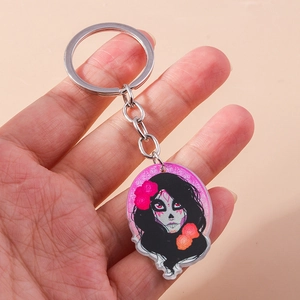 Detailed close-up of a Day of the Dead acrylic keychain with colorful sugar skull lady art