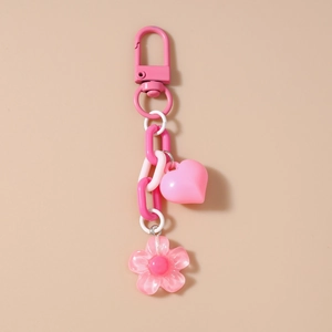 Close-up of pink heart and flower charms with metal lobster clasp and plastic chain