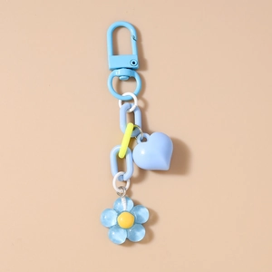 Detail of blue 3D heart and sakura flower pendant keychain with dopamine colors