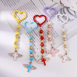 Beaded heart carabiner keychains with wing cross charms in five vibrant colors