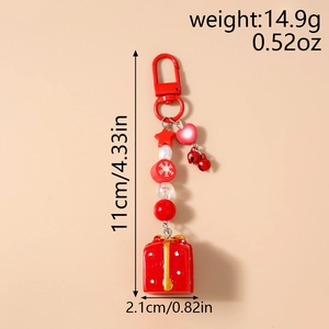Détail du porte-clés de Noël avec longueur totale de 11 cm et largeur du charm boîte cadeau