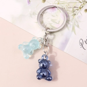 Close-up of cute dual translucent resin bear charms on a silver metal keychain ring