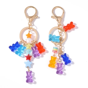 Colorful resin bear keychain with star charms and golden alloy lobster clasp on white background