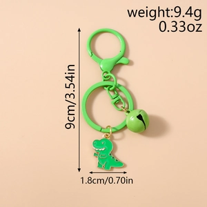 Detail view of a green dinosaur keychain with bell and lobster clasp, 9cm long and 9.4g weight