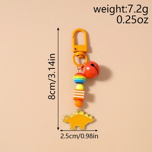 Detail view of yellow enamel stegosaurus keychain with orange beads and bell dimensions