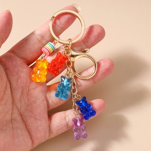 Detailed close-up of colorful resin gummy bear charms on a golden metal keychain