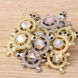 Macro detail of turtle pendants with colorful hexagon gems and sparkling rhinestones