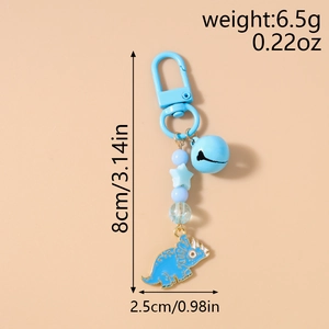 Blue dinosaur keychain with bell, star bead and enamel triceratops pendant details