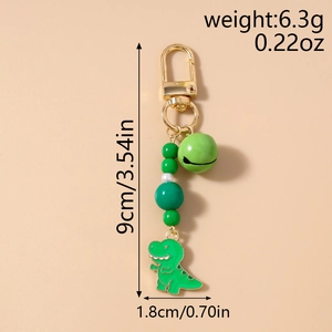 Detail of green dinosaur enamel keychain with beads, bell and size specifications