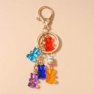Detail of colorful resin gummy bears and rainbow beads on a gold-tone metal keychain