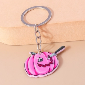 Detail of pink pumpkin halloween keychain with knife element and silver metal ring