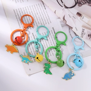 Cute enamel dinosaur keychain set with colorful bells and metal rings in four vibrant colors