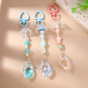 Ocean theme keychain with resin conch shell charms and colorful star beads on light background