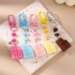 Five assorted colors of realistic milk chocolate resin keychains with gold D-rings