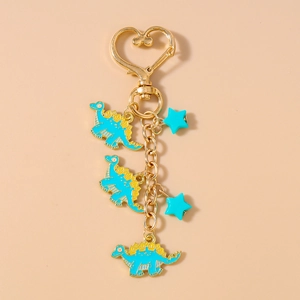 Detail of blue dinosaur keychain with heart buckle and oil-dripping star pendants
