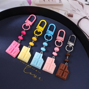 Five colorful milk chocolate block silicone keychains set on a blue display tray