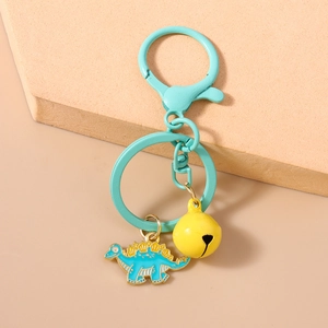 Detailed top view of light blue dinosaur keychain with yellow bell and lobster clasp