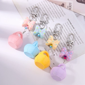 Fashionable macaron-colored mini woven basket keychains with dotted bows in four colors