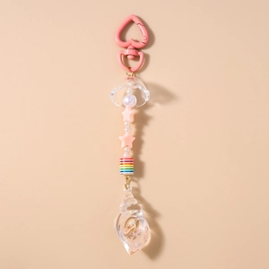 Detail of pink heart-shaped buckle and transparent conch pendant with inner shells