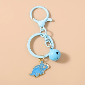 Detail showing a light blue enamel dinosaur keychain with matching bell and blue metal clasp