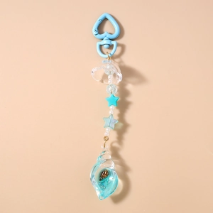 Close-up of beaded keychain featuring a gradient blue seashell pendant and heart clasp