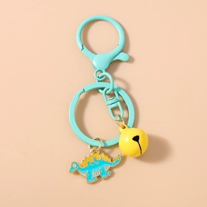 Detail of cute blue and yellow dinosaur keychain with mint green clip and yellow bell