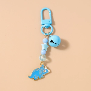 Detail of blue triceratops charm with matching beads and bell on a lobster clasp