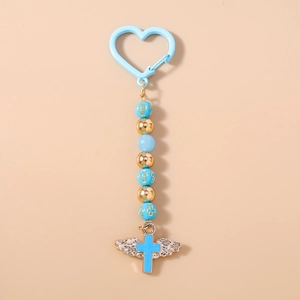 Detail shot of heart carabiner with blue beads and angel wing cross pendant