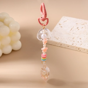 Detail of pink jellyfish keychain with star beads and conch pendant for bag decoration