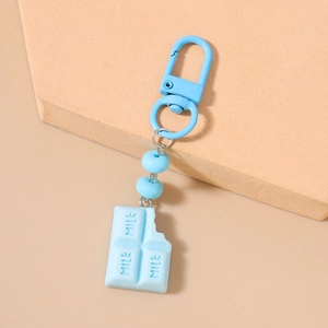 Detail of light blue chocolate bar keychain with milk engraving and large lobster clasp