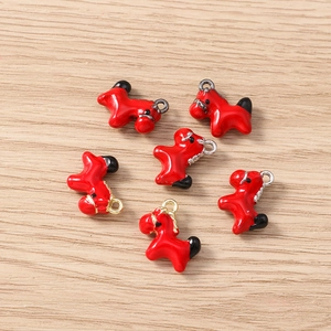 Macro detail of red enamel horse pendants for DIY jewelry making and charms
