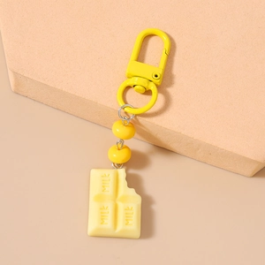 Detail of yellow milk chocolate keychain with zinc alloy D-ring and decorative beads