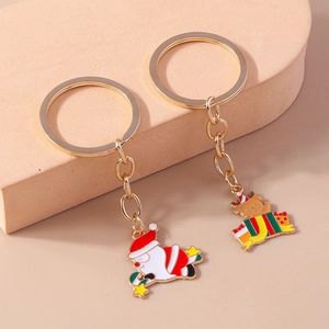 Détails des porte-clés de Noël dorés avec Père Noël et renne en émail coloré brillant