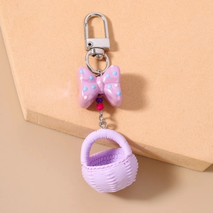 Detailed macro view of light purple polka dot bow and woven basket keychain pendant
