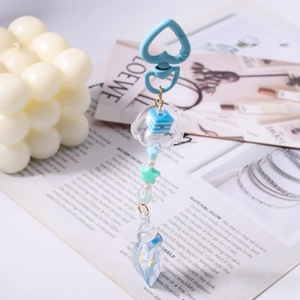 Detailed view of ocean-style keychain featuring a blue jellyfish and seashell charm