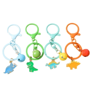 Set of four colorful enamel dinosaur keychains with bells and metal hooks on white background
