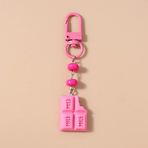 Close-up of pink chocolate bar keychain with milk engraving and metal lobster clasp