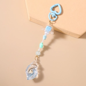 Detail of a coastal-themed keychain featuring translucent jellyfish and starfish beads
