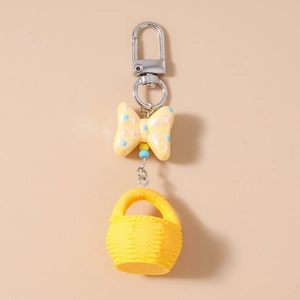 Detailed view of a yellow macaron bow basket keychain with realistic resin woven texture