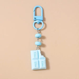 Close-up of sky blue faux chocolate bar pendant keychain with milk text and lobster clasp