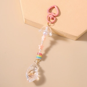 Detail of pink heart-shaped hook keychain with starfish beads and small seashell charms