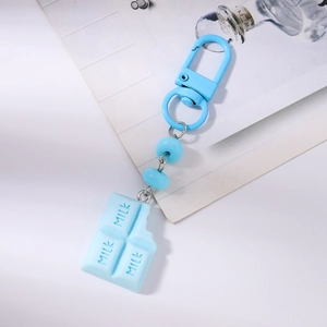 Close-up of light blue milk chocolate pendant keychain with beads and lobster clasp