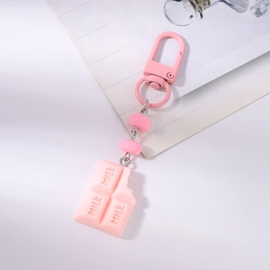 Pink chocolate bar keychain with MILK engraving and metallic hook on white background