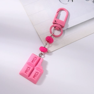 Detailed close-up of a pink resin chocolate keychain featuring embossed MILK text