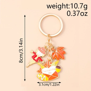 Detailed view of Thanksgiving keychain with scarecrow and maple leaf charm measurements