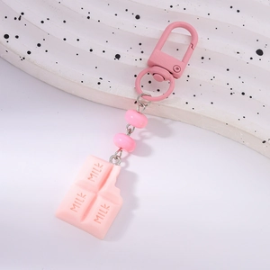 Detail of pink milk chocolate keychain with beads and a D-shaped metal clasp