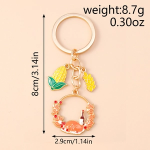 Detail view of Thanksgiving turkey and corn keychain with precise size and weight markings