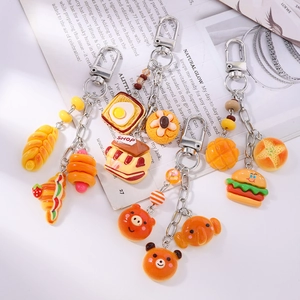 Cute resin food and animal keychains featuring bread and bear charms for women