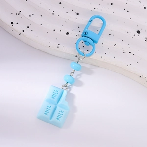 Detail of light blue milk chocolate pendant with MILK text and matching spring hook clip
