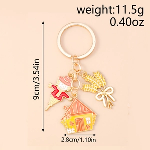 Detail view of harvest keychain with dimensions and weight info for scarecrow and house charm